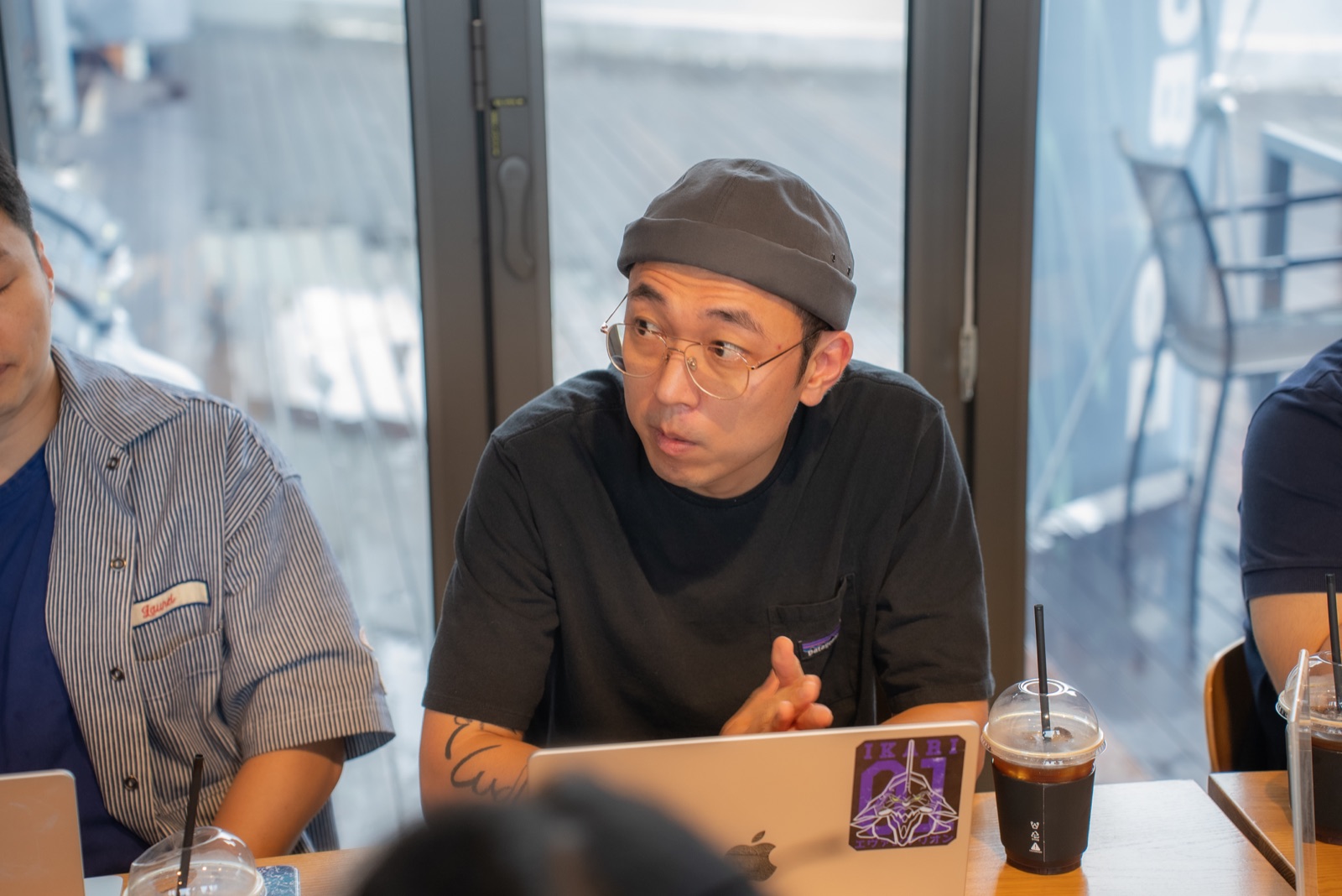 A founder sharing ideas with a laptop at the table