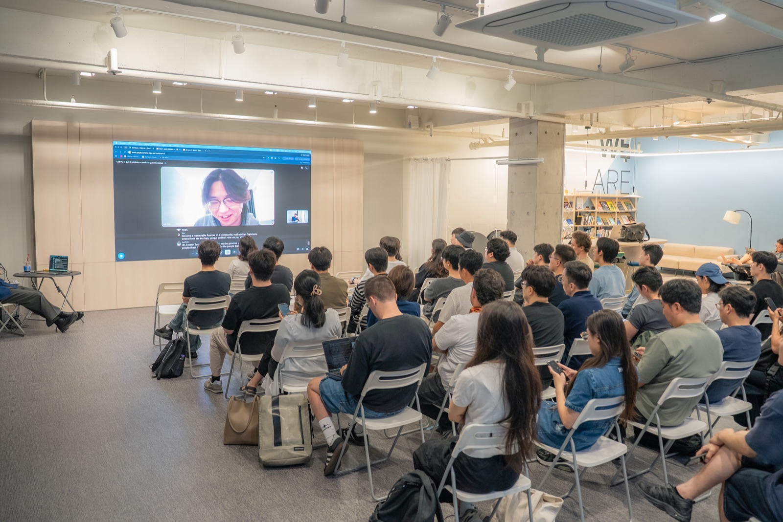 Founders listening to a remote guest speaker together